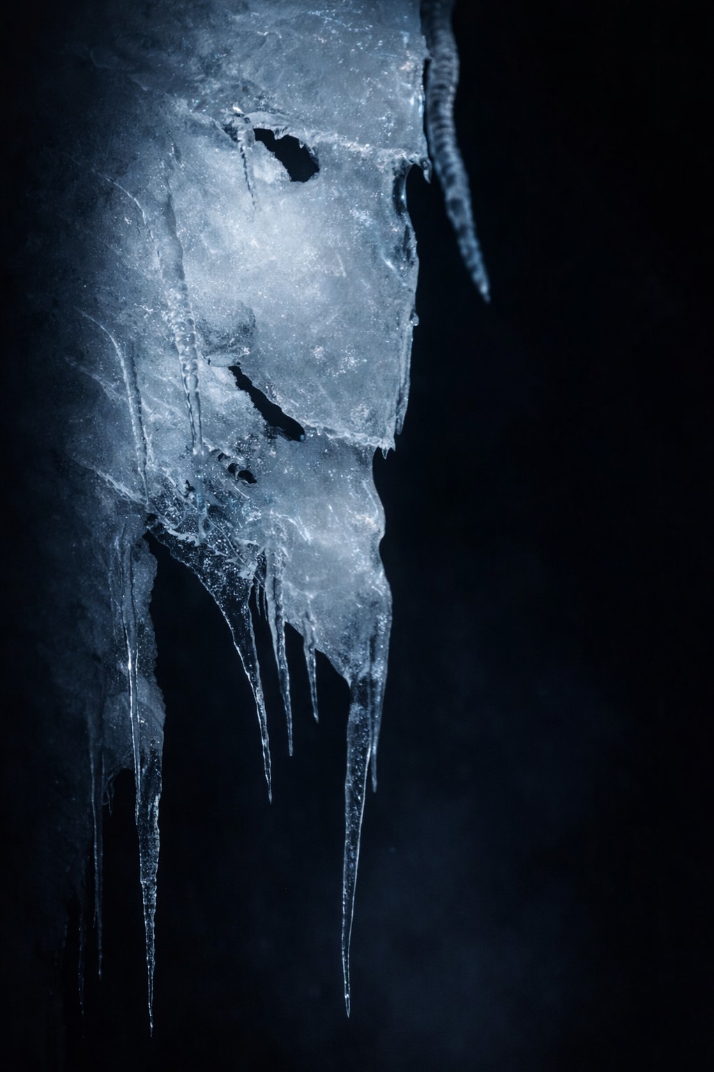 Close detail of ice formations with quiet texture and muted light.